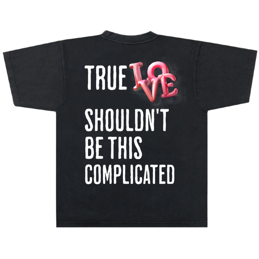 Black t-shirt with 'True Love Shouldn't Be This Complicated' text and pink heart design on a white background